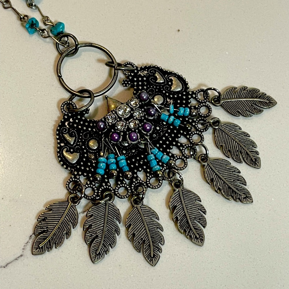 Necklace (intricate metal feathers, beads)